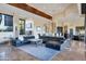 Bright and airy living room featuring modern furnishings and travertine tile flooring with golf course views at 10664 E Monument Dr, Scottsdale, AZ 85262