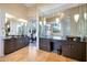 Elegant main bathroom with dual vanities, soaking tub, and large mirrors for a spa-like retreat at 10664 E Monument Dr, Scottsdale, AZ 85262