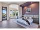 Spacious main bedroom with hardwood floors, purple accent wall, and large windows offering desert views at 10664 E Monument Dr, Scottsdale, AZ 85262