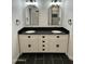 Bathroom vanity with double sinks, sleek black countertop, and elegant black hardware for a modern aesthetic at 11474 N 79Th Dr, Peoria, AZ 85345