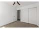 Neutral bedroom featuring carpet floors and closet with sliding doors at 11474 N 79Th Dr, Peoria, AZ 85345