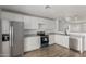 Beautiful kitchen with stainless steel appliances, white cabinets, and modern fixtures at 11474 N 79Th Dr, Peoria, AZ 85345