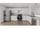 Modern kitchen featuring stainless appliances, white cabinetry, and hardwood floors at 11474 N 79Th Dr, Peoria, AZ 85345