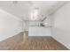 Bright living room with hardwood floors seamlessly flowing into the kitchen area at 11474 N 79Th Dr, Peoria, AZ 85345