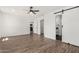 Bright main bedroom featuring wood-look floors, ceiling fan, walk-in closet and ensuite bathroom at 11474 N 79Th Dr, Peoria, AZ 85345