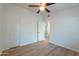 Bedroom features wood-look flooring, a ceiling fan, a closet and a door that leads to another room at 1219 E Colter St # 8, Phoenix, AZ 85014