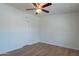 Clean bedroom with a ceiling fan, neutral walls, wood-look flooring, and closet with double doors at 1219 E Colter St # 8, Phoenix, AZ 85014