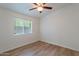 This bedroom has neutral colored walls, wood-look flooring, and a window for nice, natural light at 1219 E Colter St # 8, Phoenix, AZ 85014
