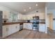 Well-equipped kitchen features stainless steel appliances, ample counter space, and white cabinets at 1219 E Colter St # 8, Phoenix, AZ 85014