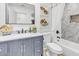 Stylish bathroom featuring marble countertops, blue vanity, and fish-themed decor at 13215 N 30Th Pl, Phoenix, AZ 85032