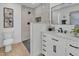 Bright bathroom with a walk-in shower, light wood floors, vanity and plenty of natural light at 13215 N 30Th Pl, Phoenix, AZ 85032