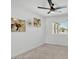 Bright bedroom with neutral walls, modern ceiling fan, and carpeted floor at 13215 N 30Th Pl, Phoenix, AZ 85032
