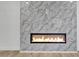 Modern fireplace featuring marble surround and a sleek, built-in design for a contemporary living space at 13215 N 30Th Pl, Phoenix, AZ 85032