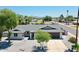 Charming single-story home with desert landscaping, grey roof, and a wide driveway at 13215 N 30Th Pl, Phoenix, AZ 85032