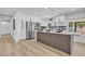 Modern kitchen features stainless steel appliances, white cabinets, a stylish island, and plenty of natural light at 13215 N 30Th Pl, Phoenix, AZ 85032