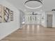 Spacious living room boasts a modern fireplace with a marble surround, bright natural light, and sleek hardwood floors at 13215 N 30Th Pl, Phoenix, AZ 85032