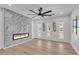 Cozy living room features a modern fireplace, large windows, recessed lighting, and seamless wood flooring at 13215 N 30Th Pl, Phoenix, AZ 85032