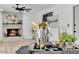 A stylish living room with a stone fireplace, ceiling fan, and an attractive tray at 13215 N 30Th Pl, Phoenix, AZ 85032