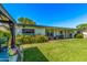 The backyard features a covered patio and lush green lawn, perfect for outdoor enjoyment at 1423 E 1St St, Mesa, AZ 85203