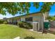 The backyard features a covered patio and lush green lawn, perfect for outdoor enjoyment at 1423 E 1St St, Mesa, AZ 85203