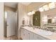 Bathroom with dual sinks, granite countertops, and a tiled shower, providing a luxurious feel at 1423 E 1St St, Mesa, AZ 85203