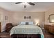 Spacious bedroom featuring hardwood floors, a ceiling fan, and a cozy seating area at 1423 E 1St St, Mesa, AZ 85203