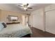 Bright bedroom featuring hardwood floors, a ceiling fan, and large closets for ample storage at 1423 E 1St St, Mesa, AZ 85203