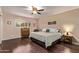 Comfortable bedroom with hardwood floors, a ceiling fan, and natural light from a window at 1423 E 1St St, Mesa, AZ 85203