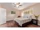 Comfortable bedroom features a ceiling fan, plantation shutters, and hardwood floors at 1423 E 1St St, Mesa, AZ 85203