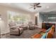 Stylish living room with a plush rug, ceiling fan, and comfortable seating near large windows at 1423 E 1St St, Mesa, AZ 85203