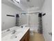 Bathroom featuring a spacious vanity, neutral tiles, and a shower-tub combo at 14728 W Redfield Rd, Surprise, AZ 85379