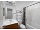 Clean bathroom with a shower-tub combo, toilet, and a wood-finished vanity with sink at 14728 W Redfield Rd, Surprise, AZ 85379