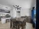 Bright dining area adjacent to the kitchen with an elegant light fixture and tile flooring at 14728 W Redfield Rd, Surprise, AZ 85379