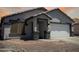 Charming single-story home with a two-car garage and low-maintenance desert landscaping at 14728 W Redfield Rd, Surprise, AZ 85379