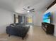 Open-concept living room with a cozy sectional sofa and sliding glass doors to the backyard at 14728 W Redfield Rd, Surprise, AZ 85379