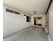The covered patio features concrete flooring, dual windows, and backyard access through sliding glass doors at 14728 W Redfield Rd, Surprise, AZ 85379