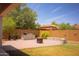 Private backyard offering a built-in grill, stone patio, and manicured lawn perfect for outdoor entertaining at 15148 W Sells Dr, Goodyear, AZ 85395