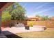 Expansive backyard features brick paver patio, built-in grill area, and mature landscaping for outdoor enjoyment at 15148 W Sells Dr, Goodyear, AZ 85395