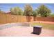 Spacious backyard with paver patio, greenery, and a block wall fence, perfect for outdoor living at 15148 W Sells Dr, Goodyear, AZ 85395