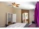 Inviting main bedroom featuring a ceiling fan, neutral walls, and open doorway to the en-suite bathroom at 15148 W Sells Dr, Goodyear, AZ 85395