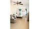 Bright bedroom with neutral decor, tile floors, and ceiling fan at 15148 W Sells Dr, Goodyear, AZ 85395