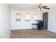 A bedroom with large windows, plush carpet, and a computer desk at 15148 W Sells Dr, Goodyear, AZ 85395