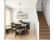 Cozy dining room featuring a chandelier, large table, and easy access to the staircase at 15148 W Sells Dr, Goodyear, AZ 85395