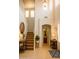 Bright foyer with high ceilings, staircase, and entry view into powder room at 15148 W Sells Dr, Goodyear, AZ 85395