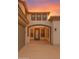 Inviting front entry with covered porch, neutral tones, and decorative architectural details at 15148 W Sells Dr, Goodyear, AZ 85395
