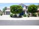 Charming two-story home with landscaped yard and a blue front door at 15148 W Sells Dr, Goodyear, AZ 85395