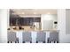 A modern kitchen with stainless steel appliances and breakfast bar seating for casual dining at 15148 W Sells Dr, Goodyear, AZ 85395