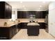 Spacious kitchen with granite countertops, stainless steel appliances, and a convenient center island at 15148 W Sells Dr, Goodyear, AZ 85395