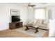 Comfortable living room featuring a modern media center, plush sofa, and natural light at 15148 W Sells Dr, Goodyear, AZ 85395