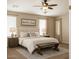 Relaxing primary bedroom features a plush bed, and a cozy bench at 15148 W Sells Dr, Goodyear, AZ 85395